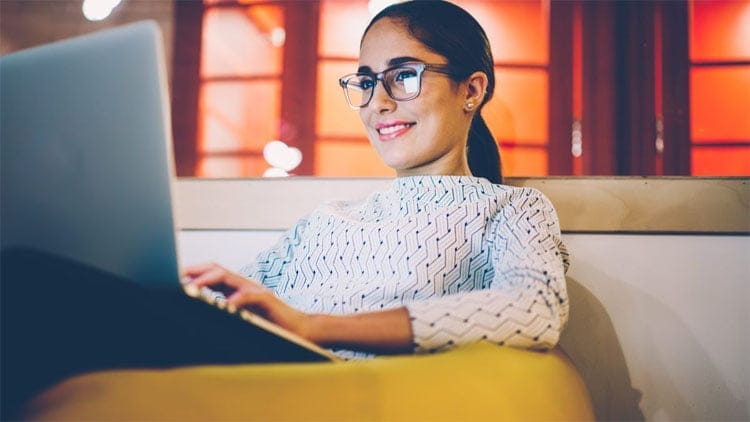 Woman-watching-laptop-in-leather-beanbag-1200x675