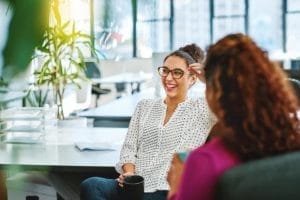 Two women in office discussing flexible public holidays